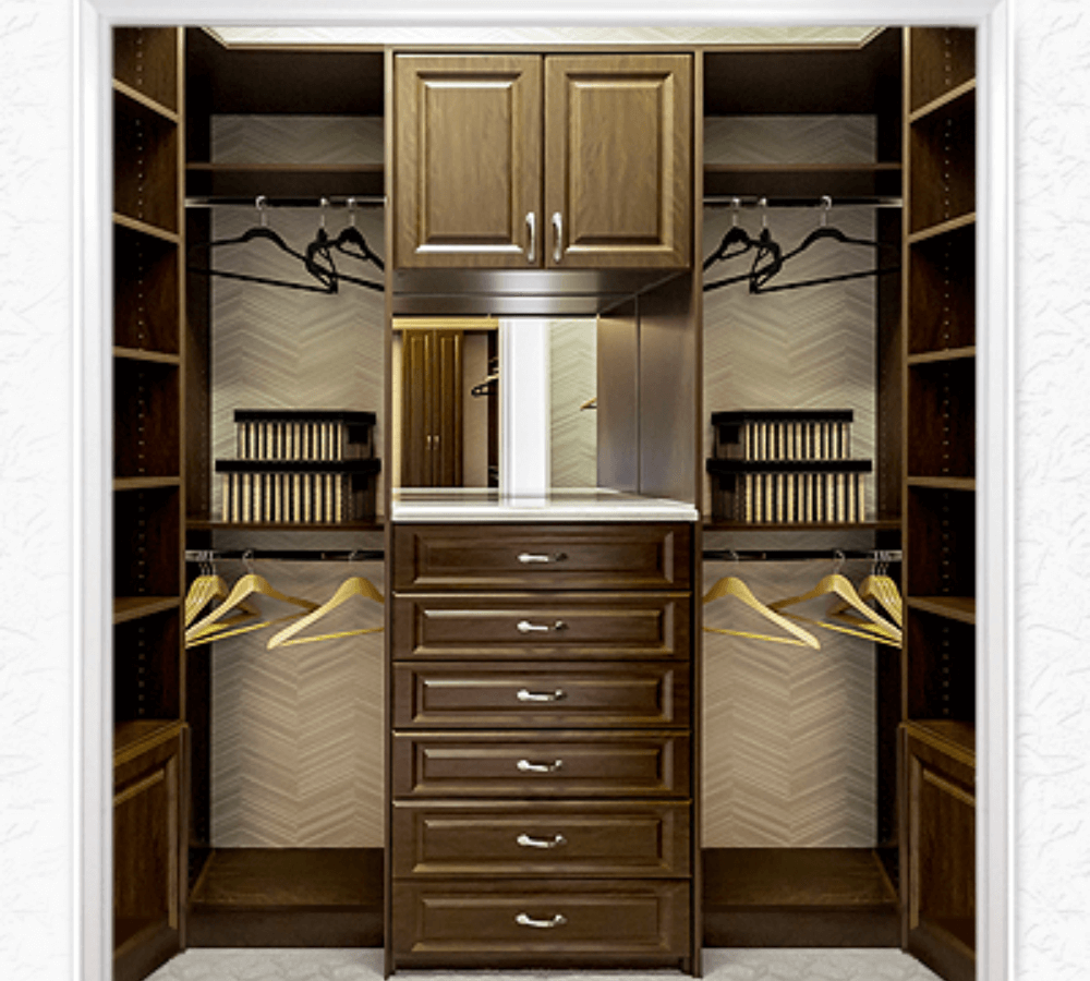 A brown and tan closet with drawers, hangar space and shelves.