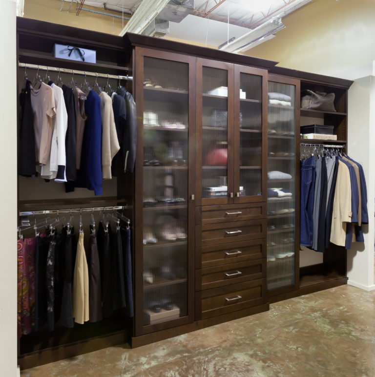 Woman organizing clothing in a closet